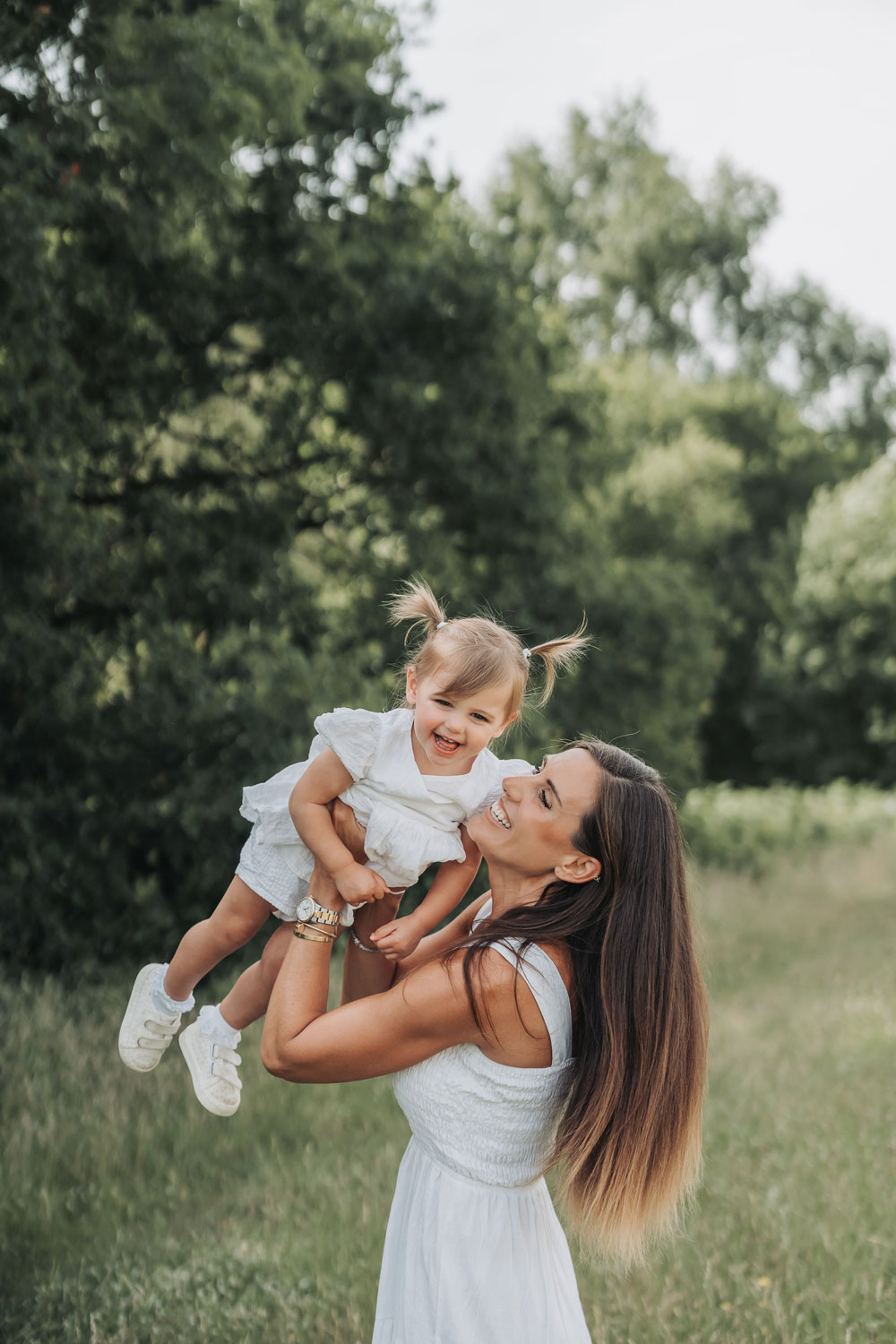 Warwickshire summer meadow photoshoot with mum flying daughter and laughing