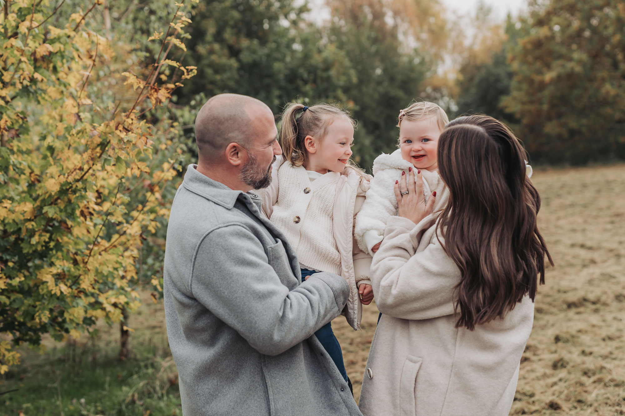 Warwickshire outdoor autumn family photoshoot with family cuddling