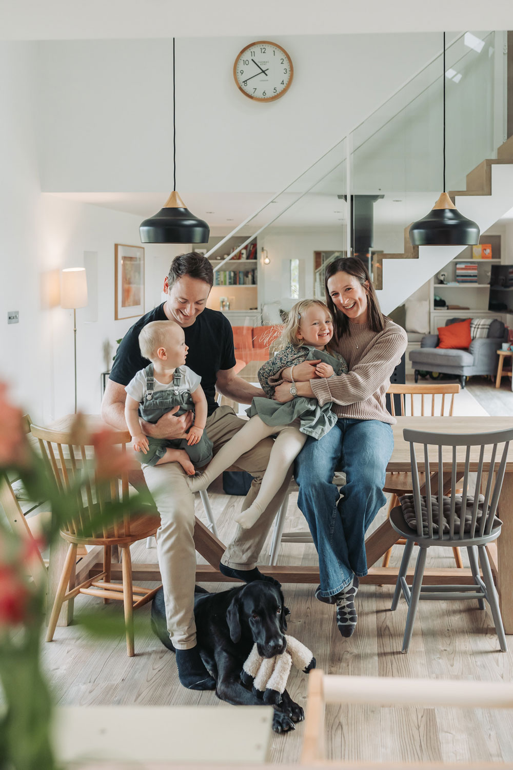 In home family photoshoot with family cuddling on dining table