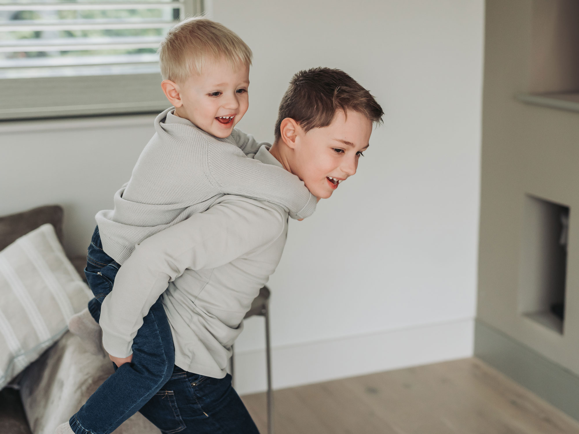 Stratford-Upon-Avon newborn photoshoot with brothers having piggy back rides