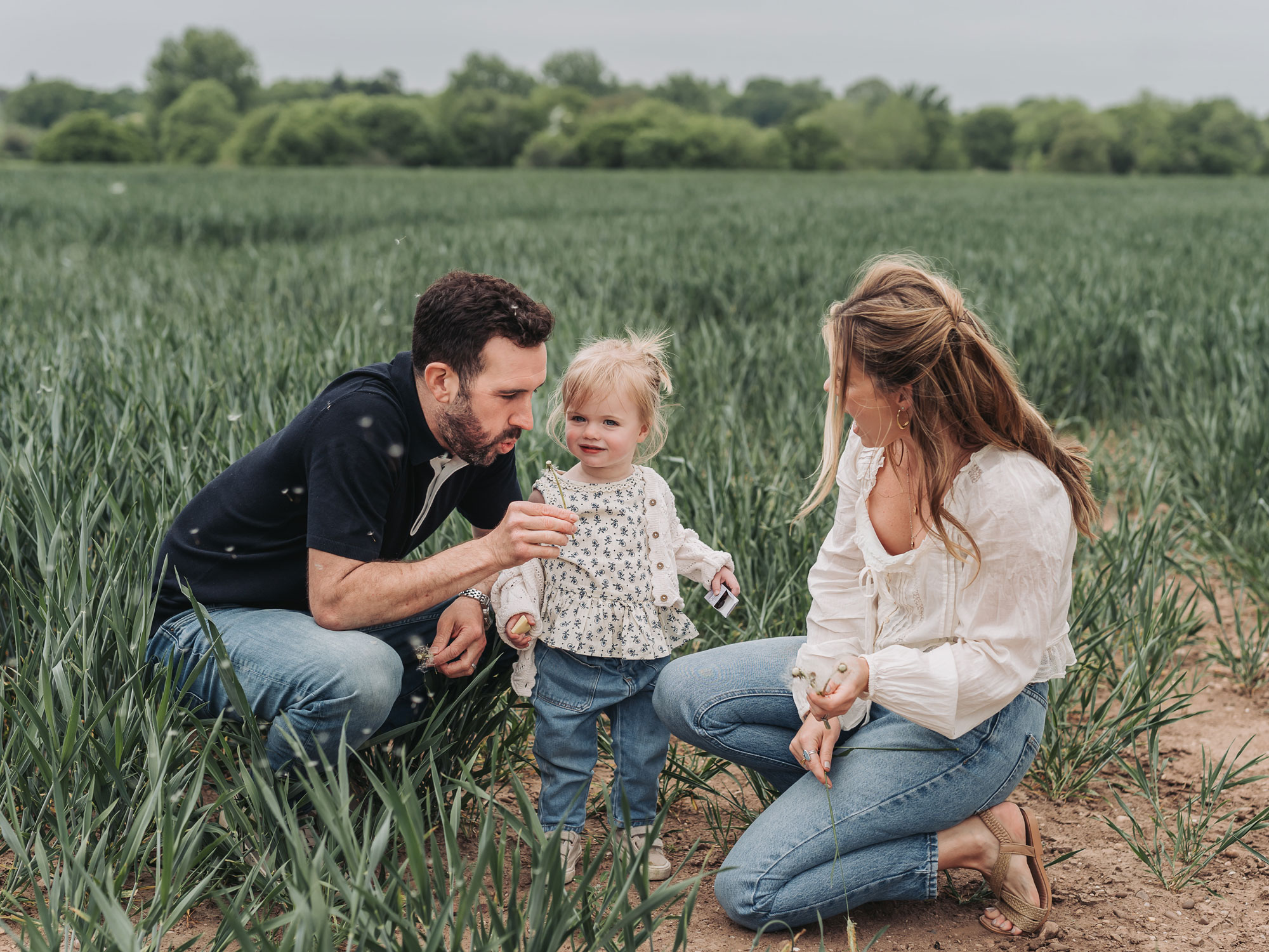Warwickshire crop field photoshoot with family blowing dandelions