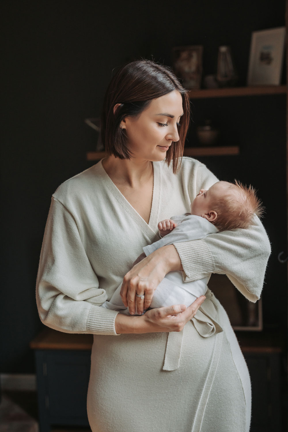 Mum wearing beige dress holding baby