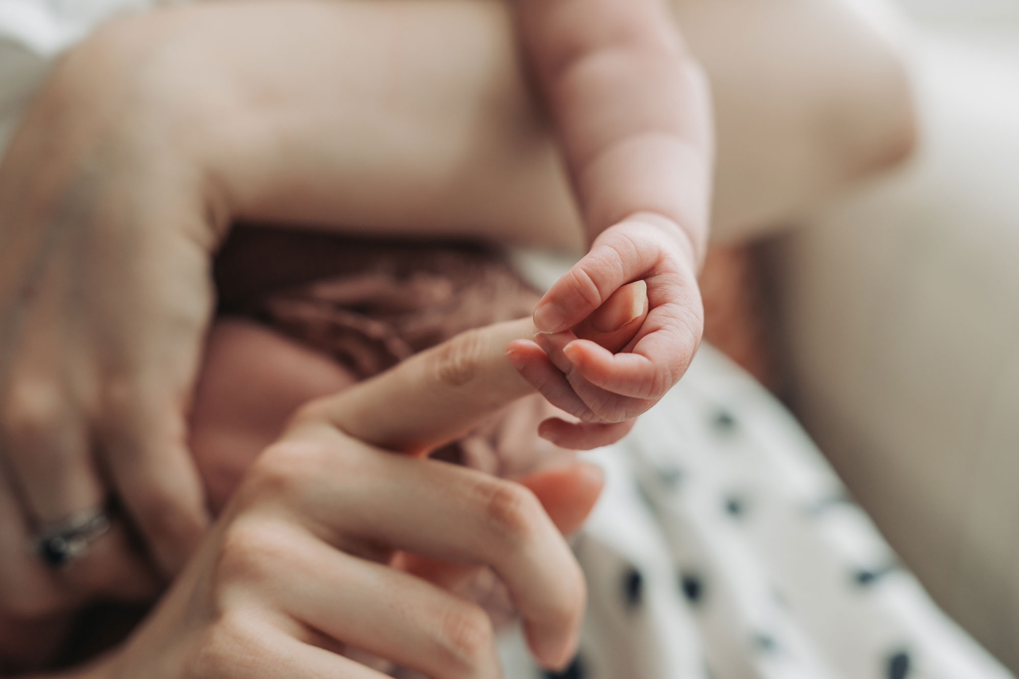 Baby holding mum's fingers