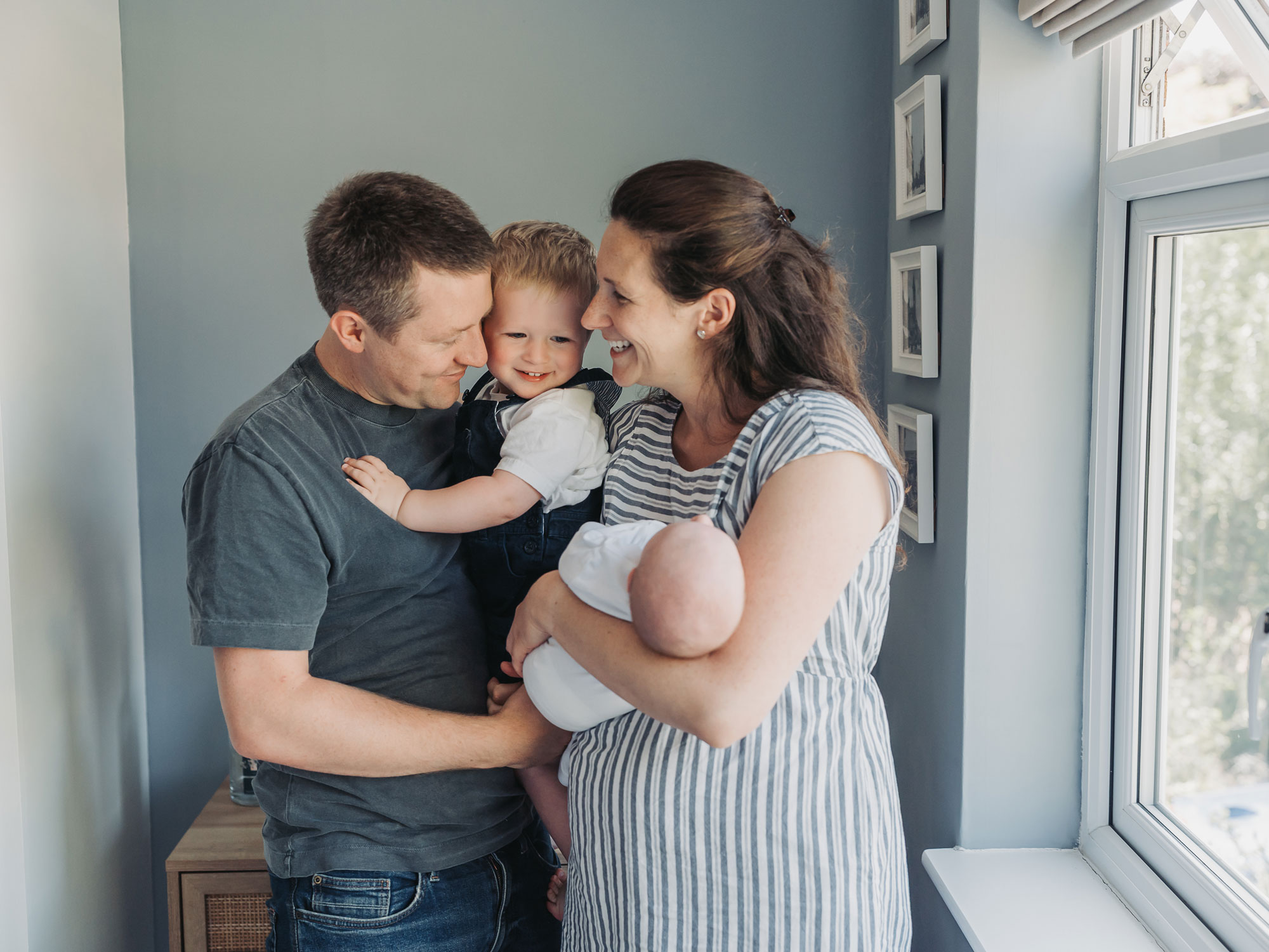 Warwickshire family cuddling together during at home newborn photoshoot