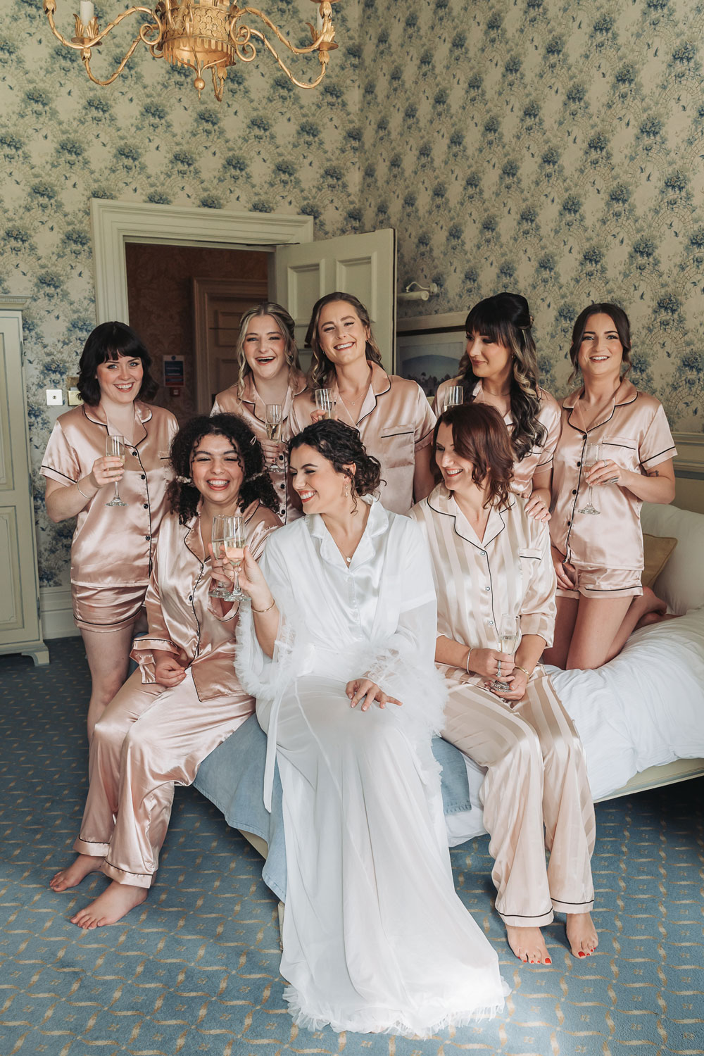 Kilworth house wedding with bride and bridesmaids on bed group photo