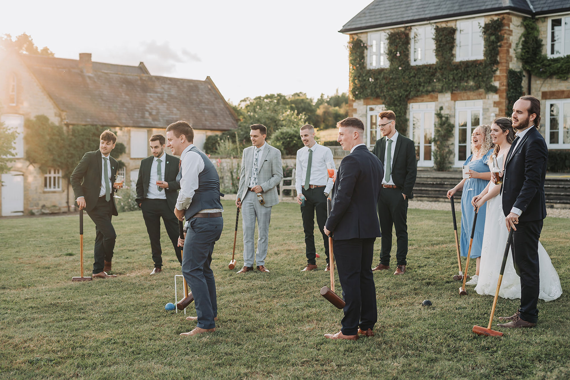 Longbourn estate barn wedding photography with wedding guests playing croquet at sunset