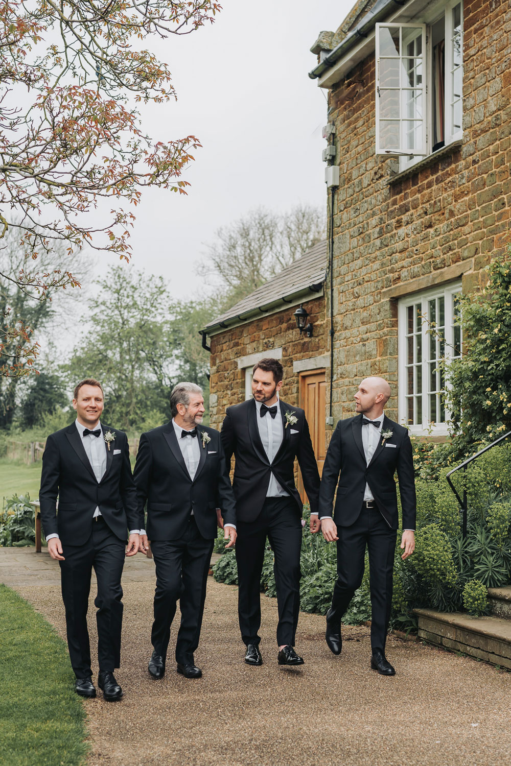 Groomsmen group shot walking outside Crockwell Farm wedding venue