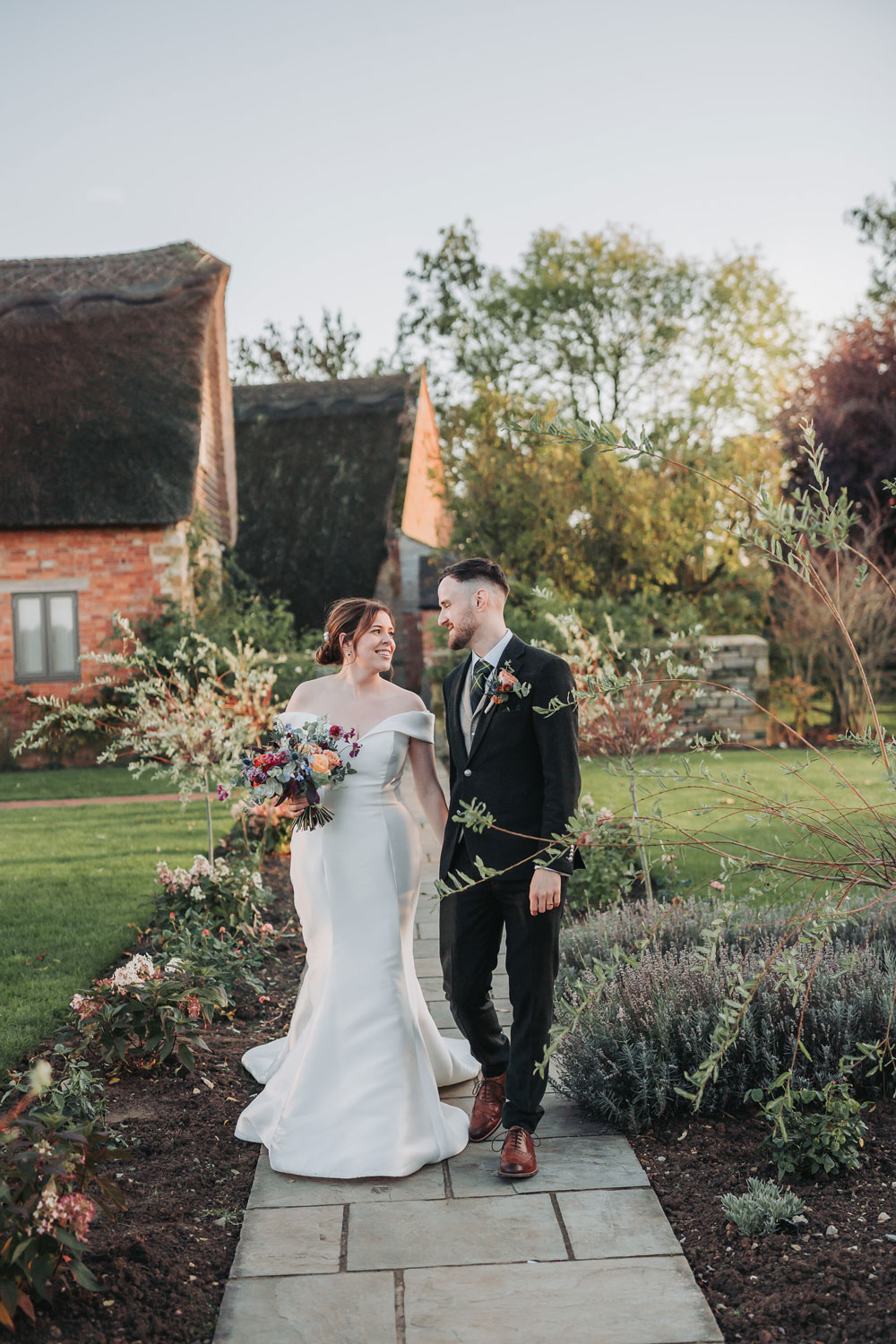 Couple portrait at autumn Blackwell Grange wedding with colour bridal bouquet