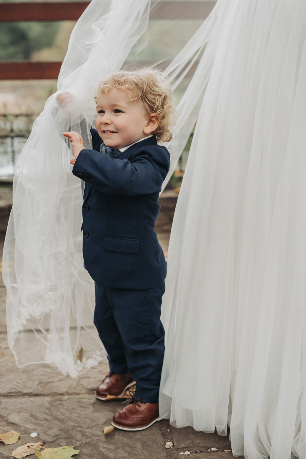 Page boy under veil at Saxon Mill wedding Warwickshire