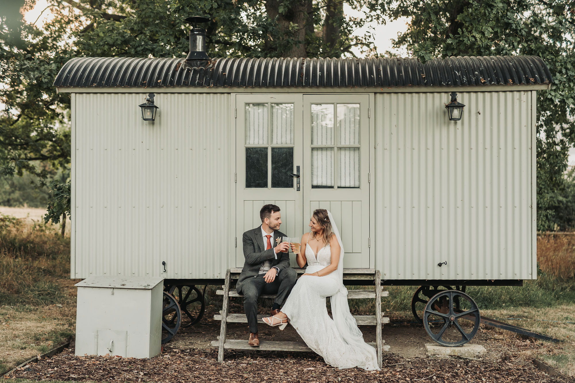 Bride and groom cheers with cider cups at Park Farm wedding