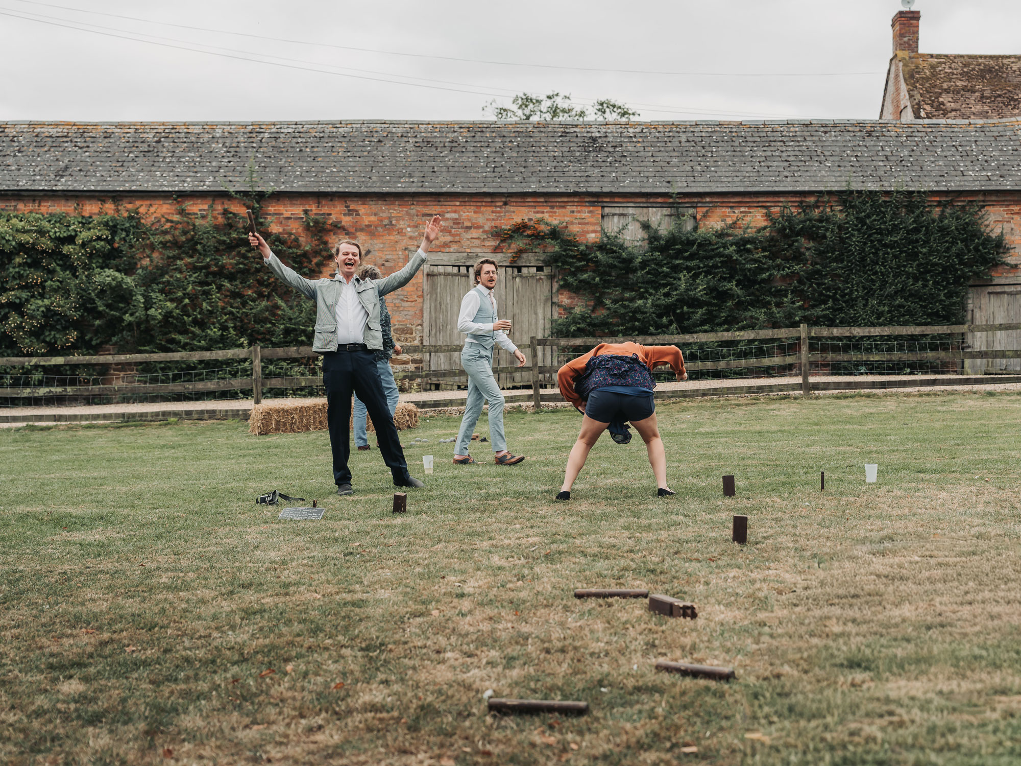 Lawn games at Park Farm wedding with guests bending over