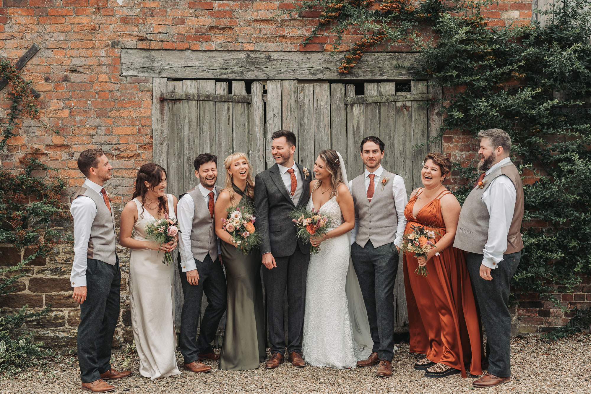 Bridal and groom's party laughing group photo at Park Farm weddings