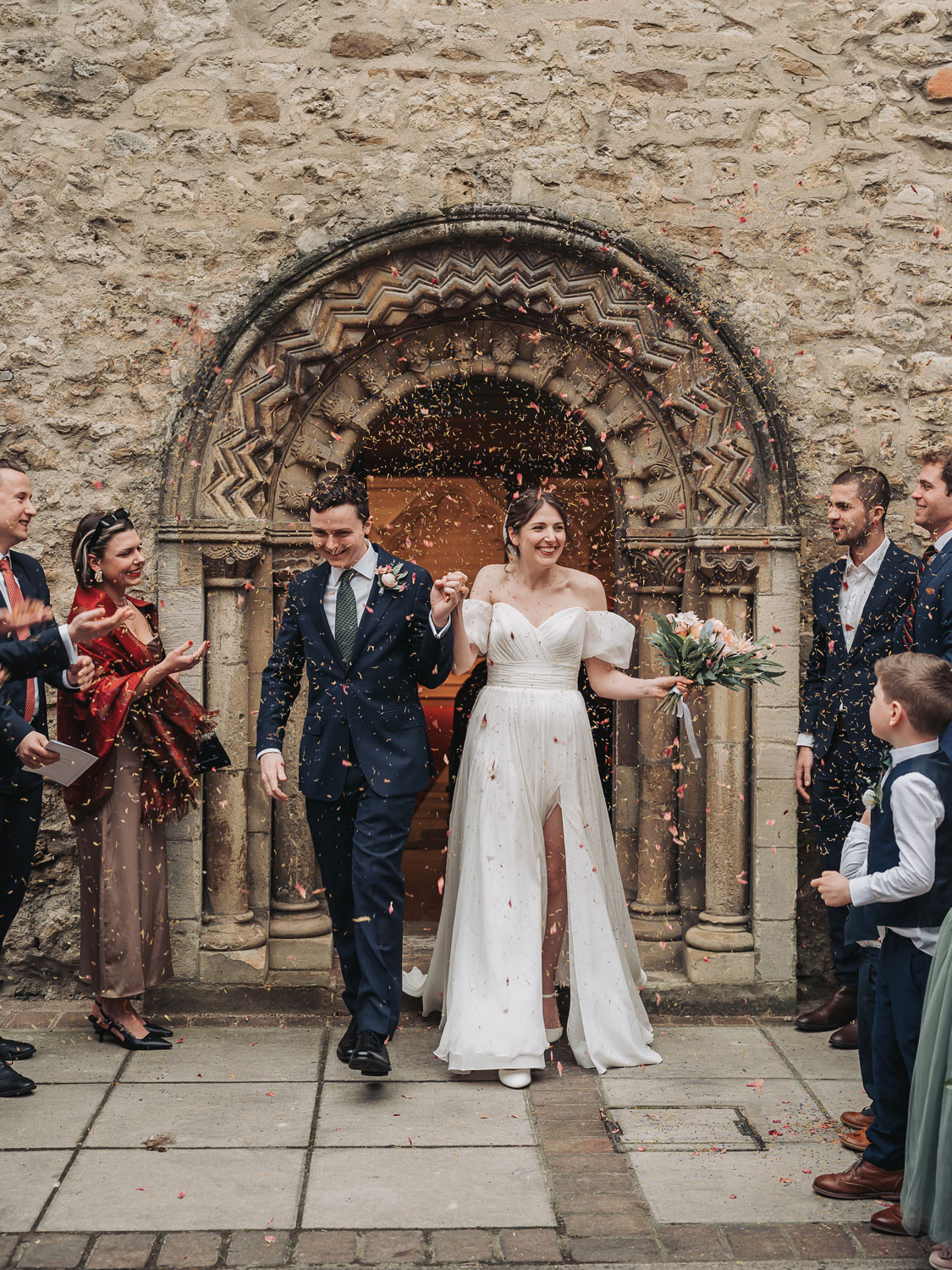 Confetti photo of bride and groom outside of St Ebbe's church in Oxford