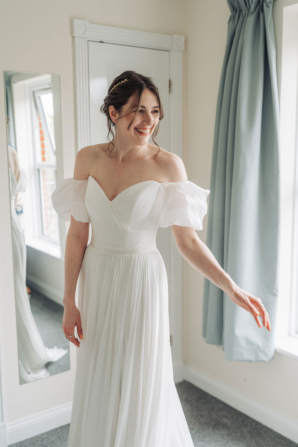 Bride laughing over her shoulder at bridal prep in Oxford