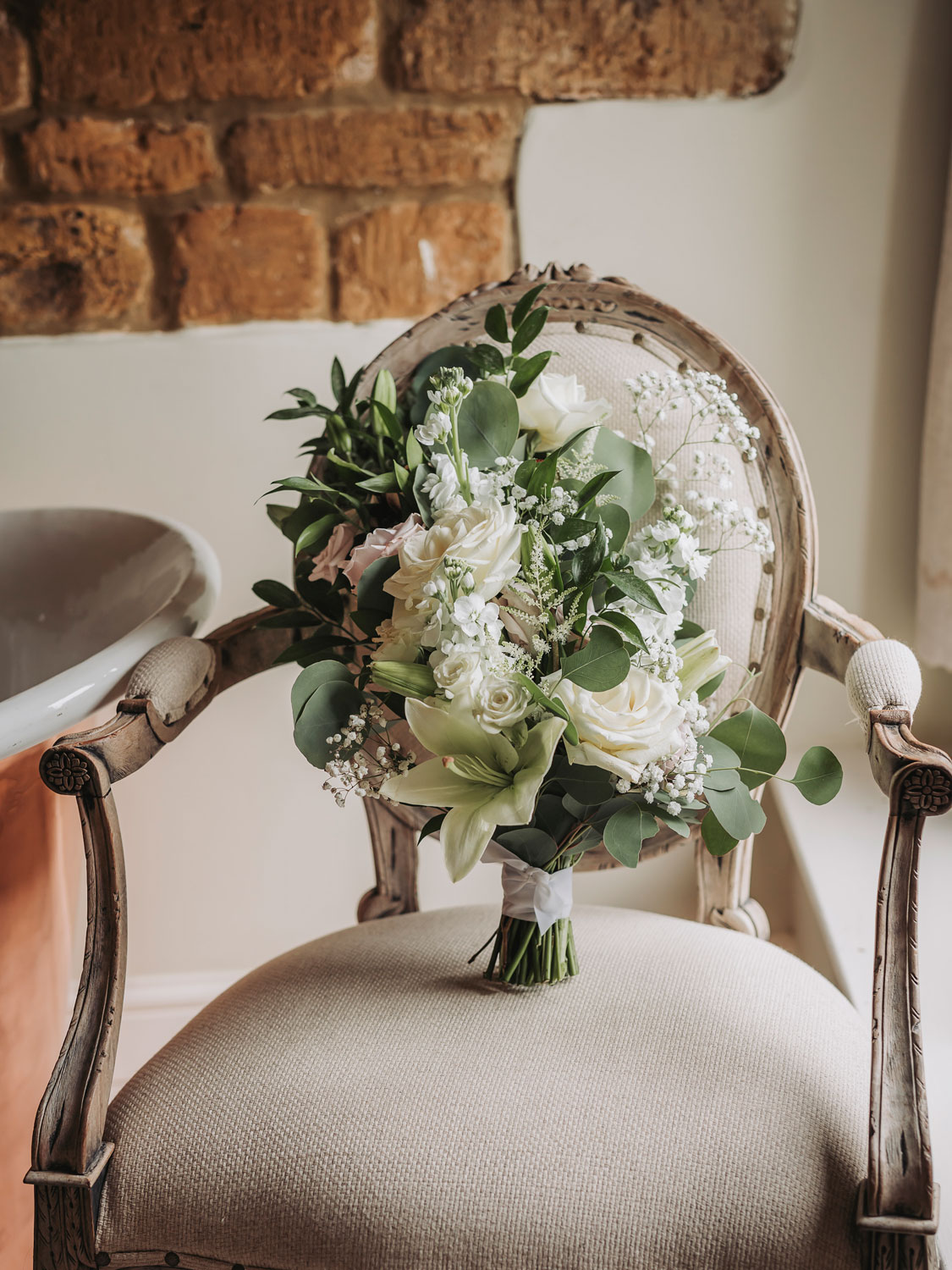 White bridal bouquet on chair of Crockwell Farm