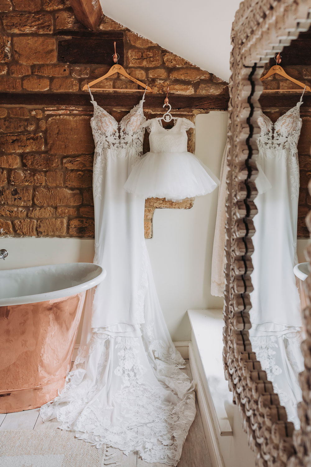 Bride and flower girl dress hung up at Crockwell Farm wedding venue