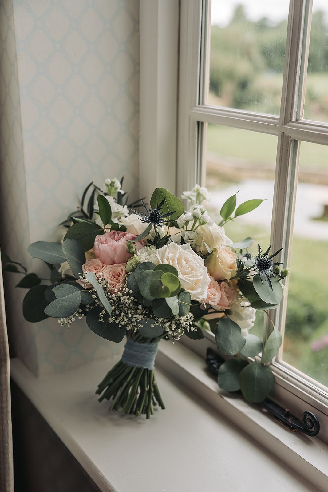 Blush and green wedding bouquet with Scottish thistles