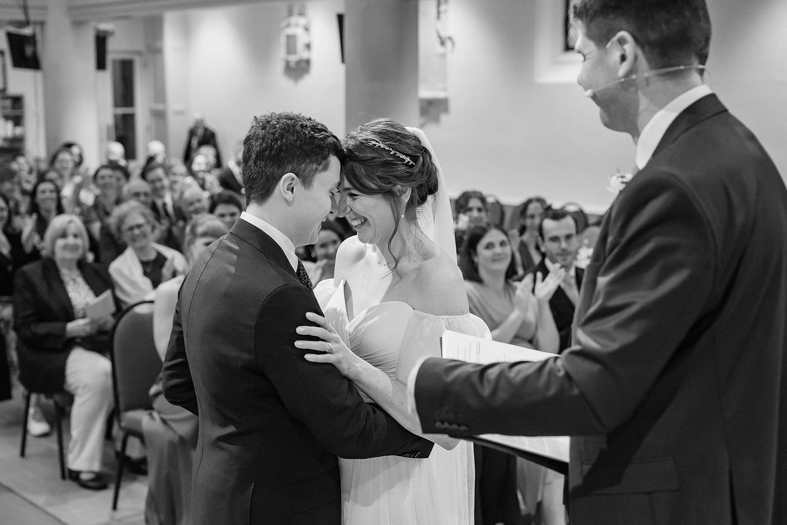Black and white photo of bride and groom with heads together