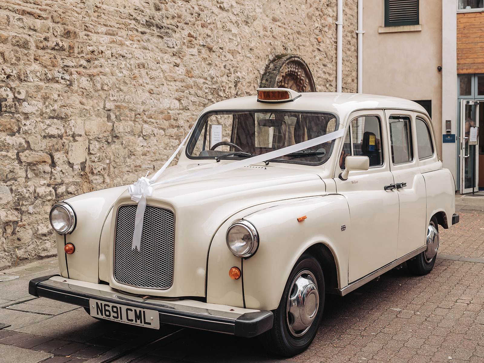 White wedding taxi with ribbons