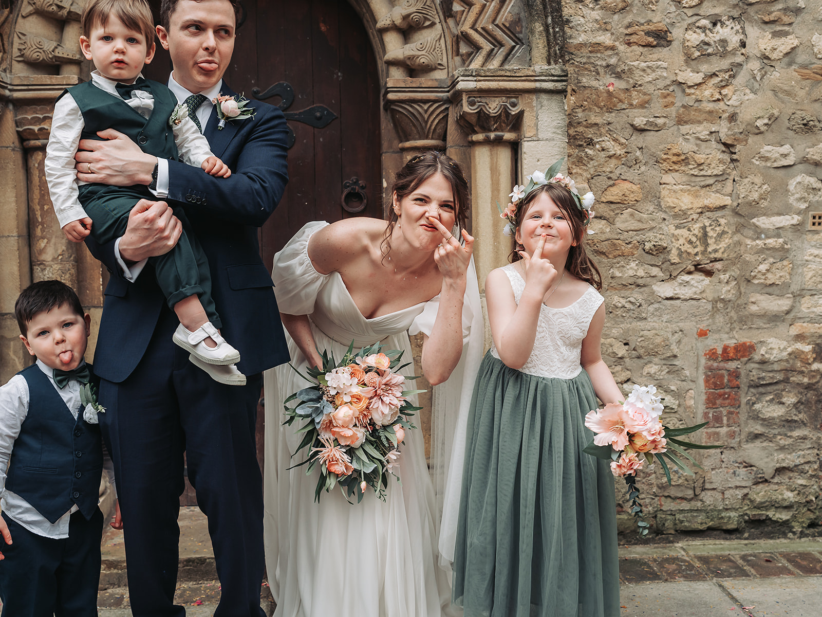 Bride and flower girl making faces at camera
