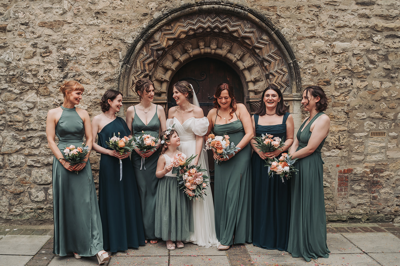 Bride and bridesmaids wearing emerald outside St Ebbe's