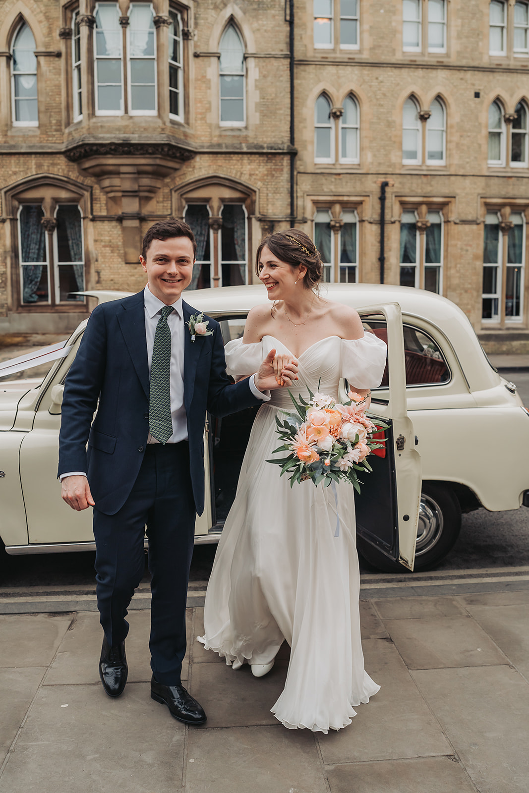 Wedding couple walking away from white wedding taxi at Ashmolean Museum