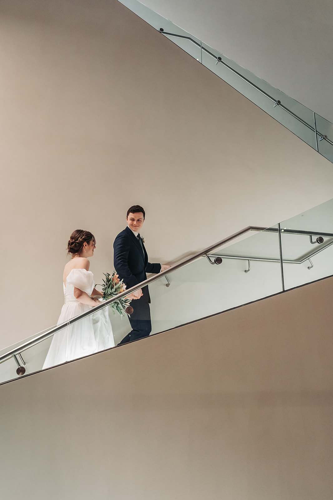 wedding couple walking up stairs in Ashmolean museum