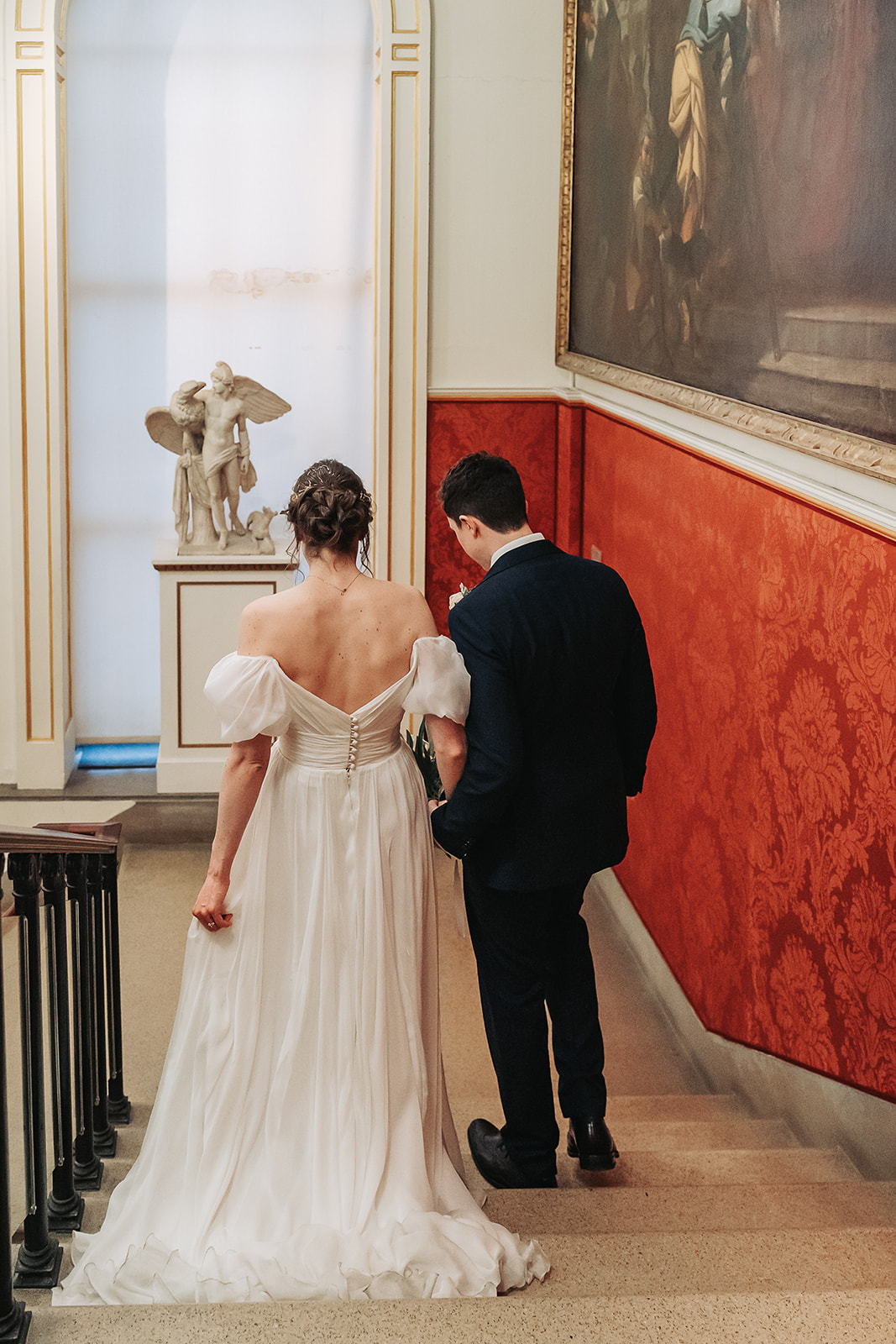 Bride and groom walking down the stairs at Ashmolean museum