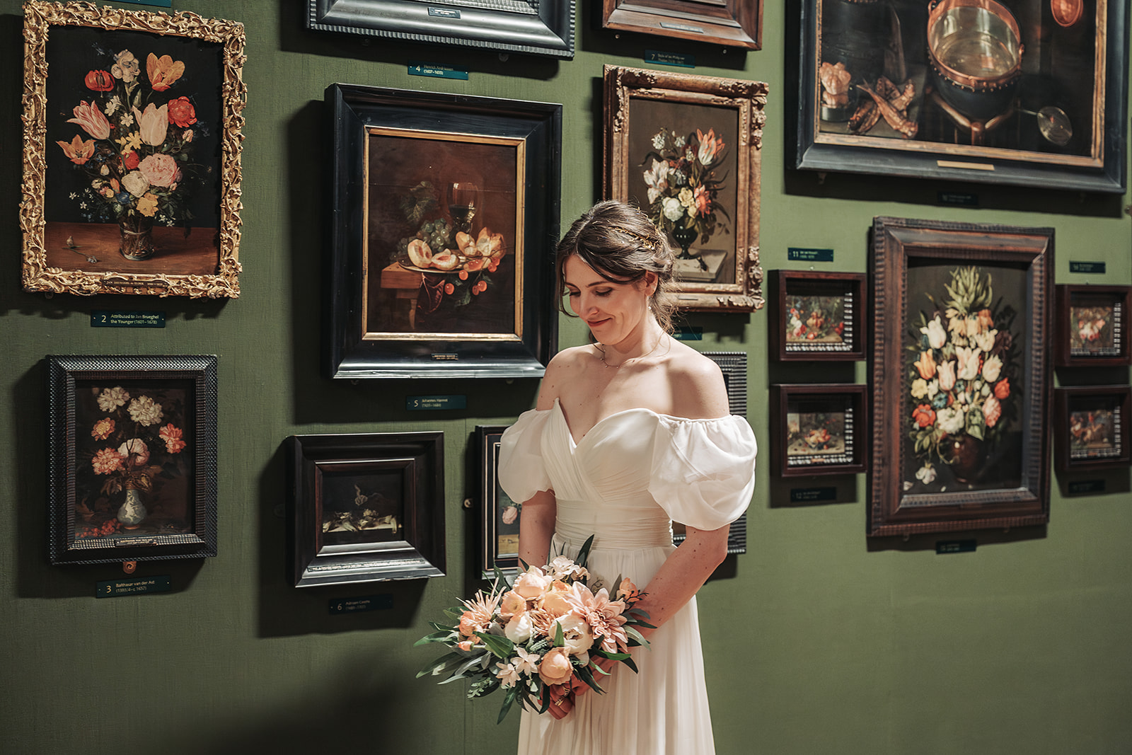 Bride looking down at bouquet in Ashmolean museum