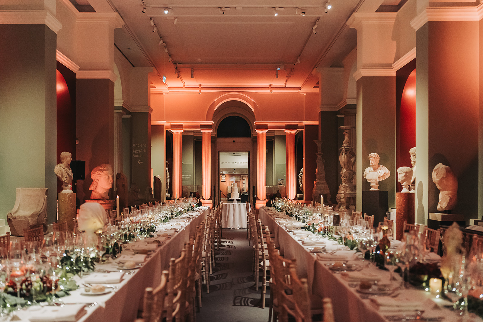 two long tables with cake in the middle of sculpture gallery of Ashmolean museum