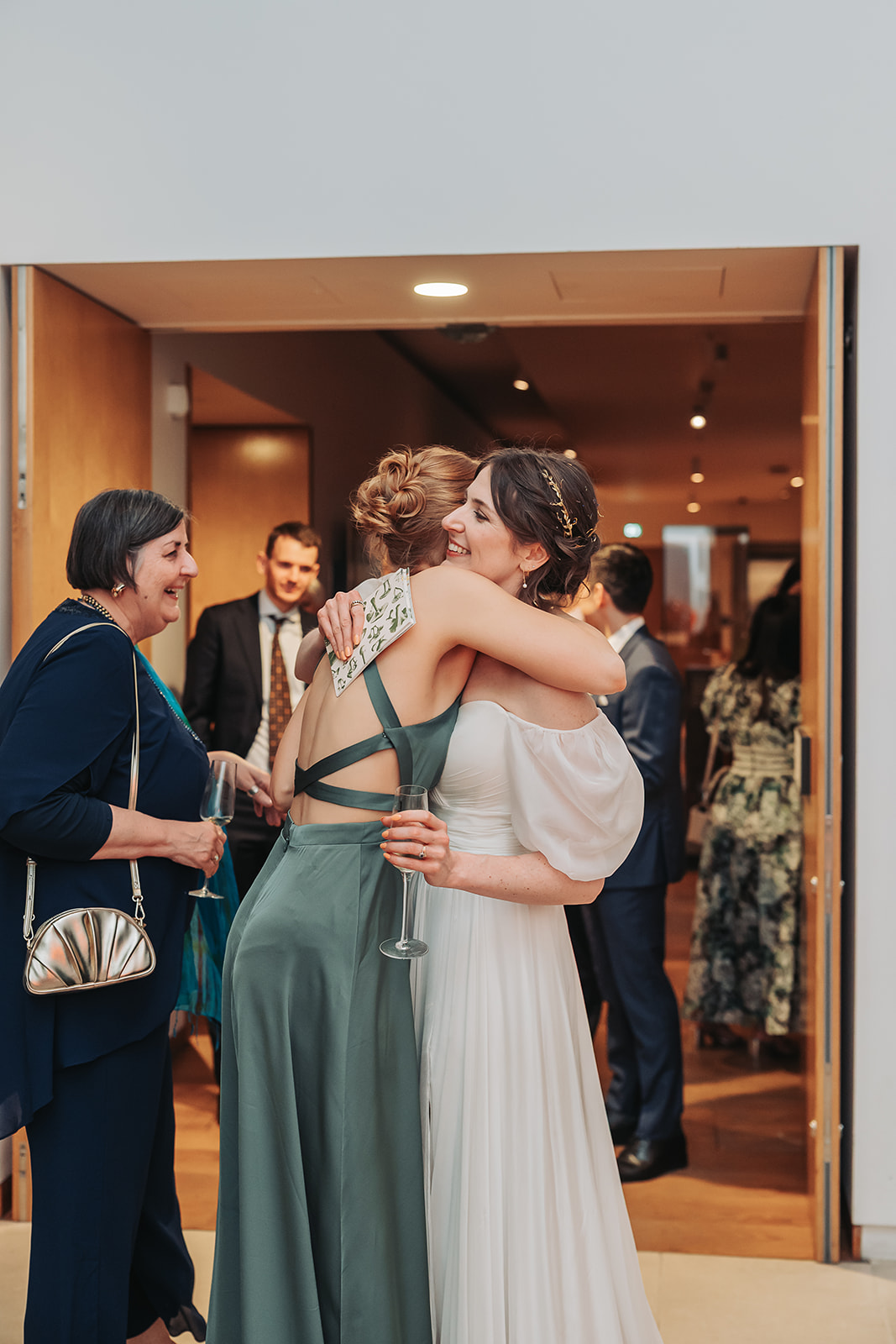 Bride giving bridesmaid a hug