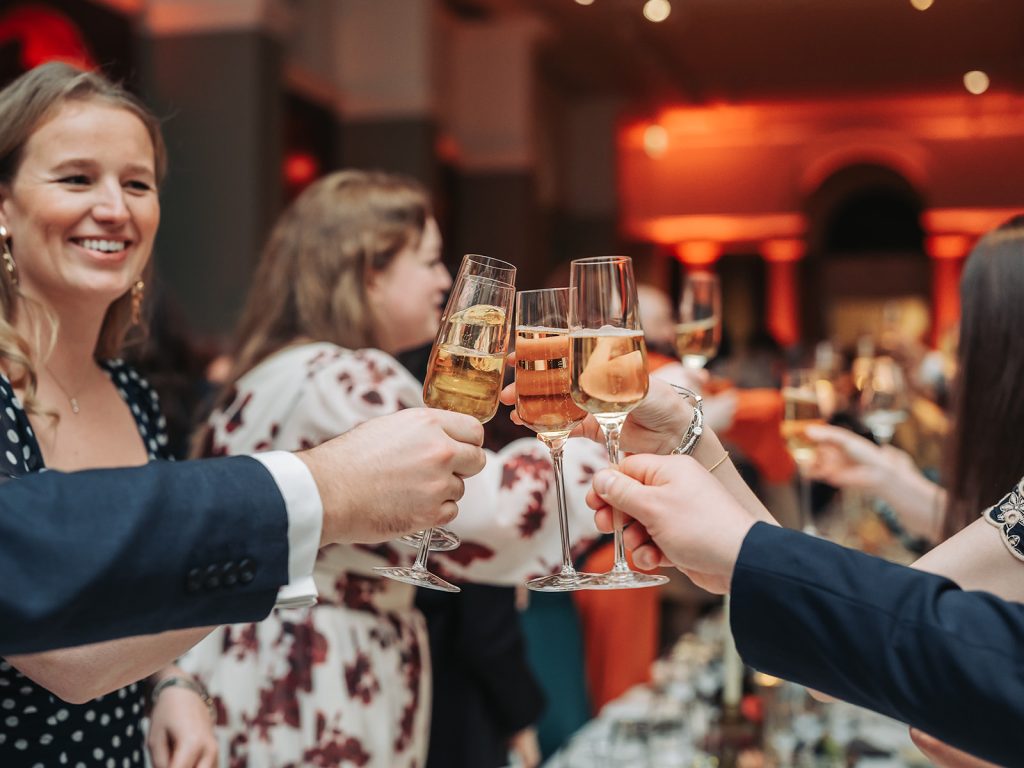 three champagne glasses clinking