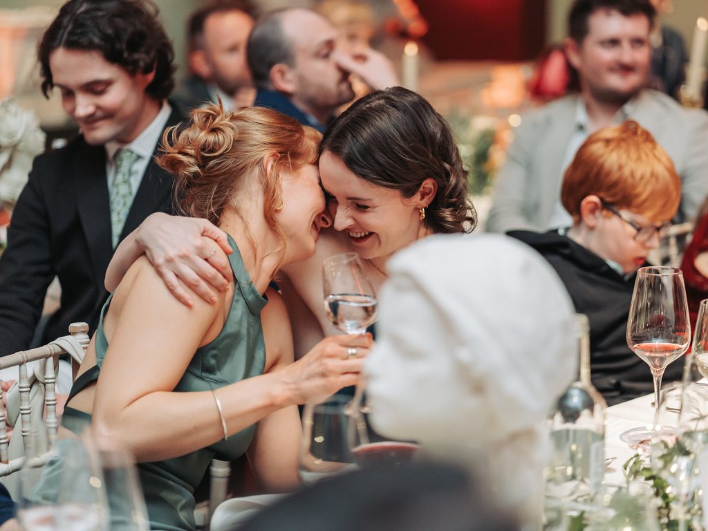 Bridesmaids hugging and laughing together
