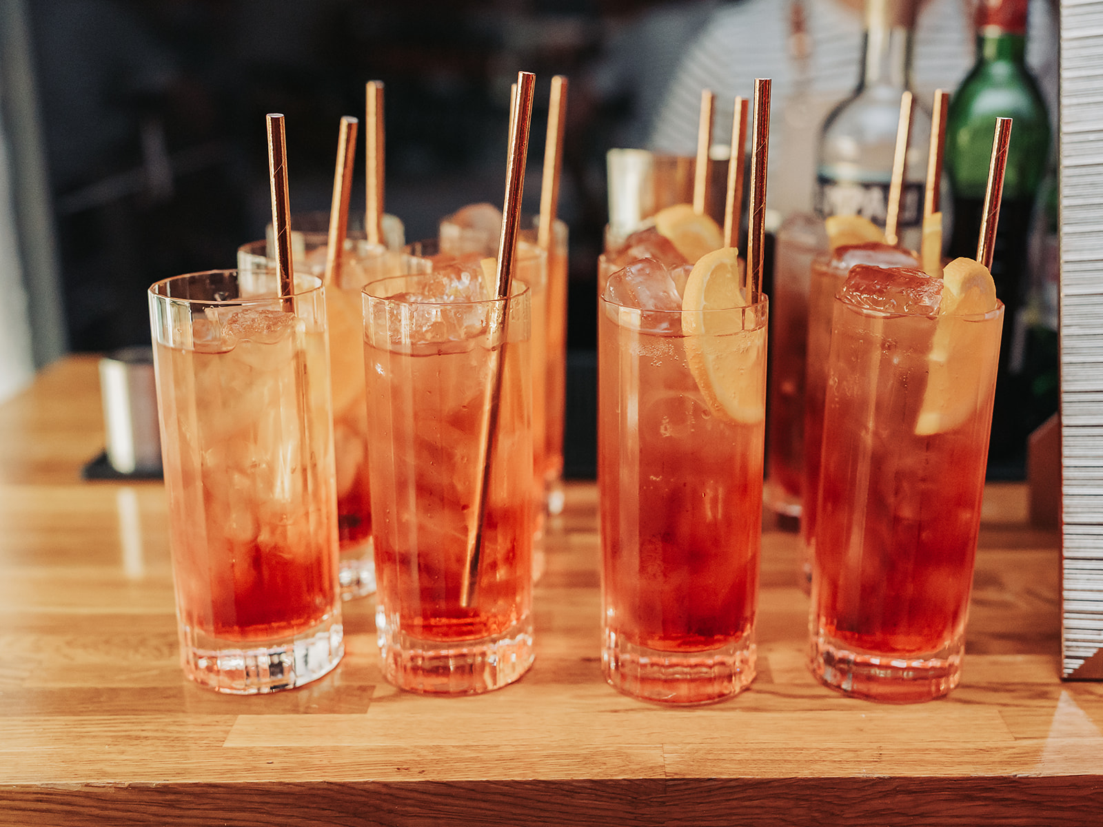 Orange cocktails lined up with orange slices