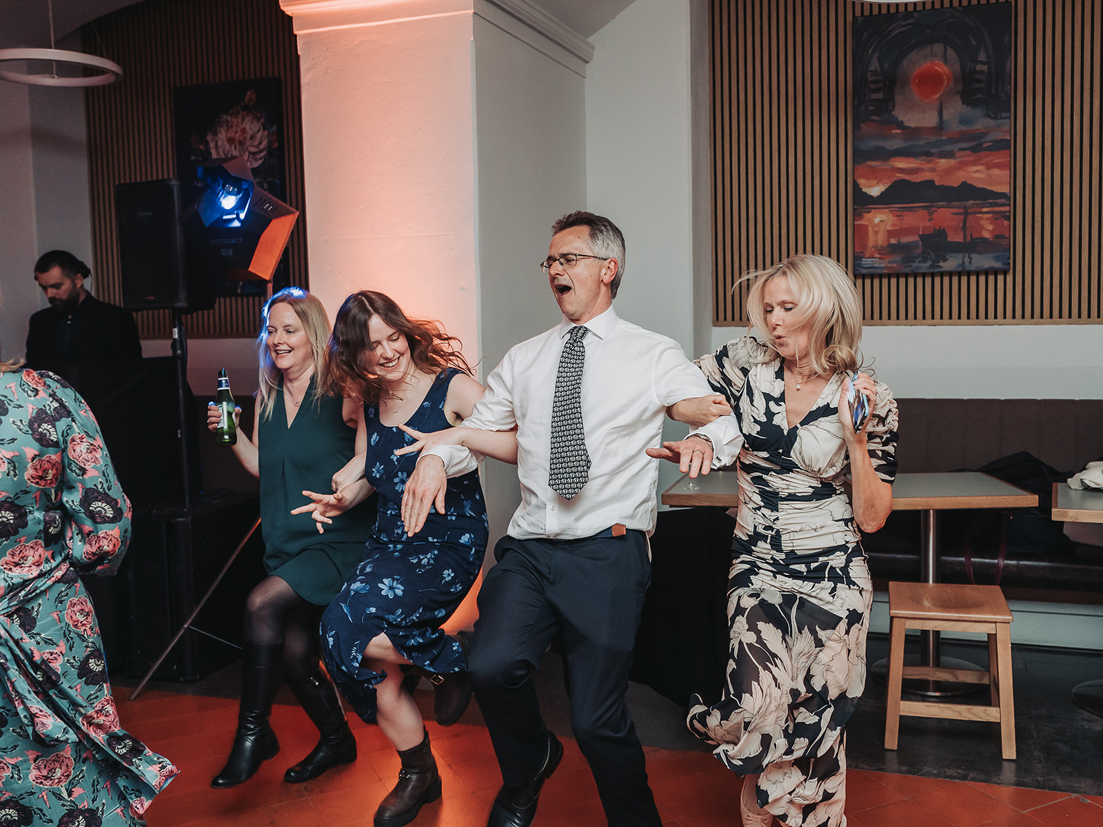 Wedding guests with arms linked dancing in the vaults of Ashmolean Museum