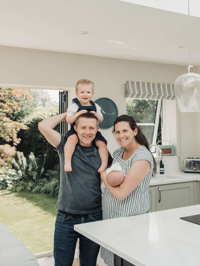 Family portrait smiling in kitchen