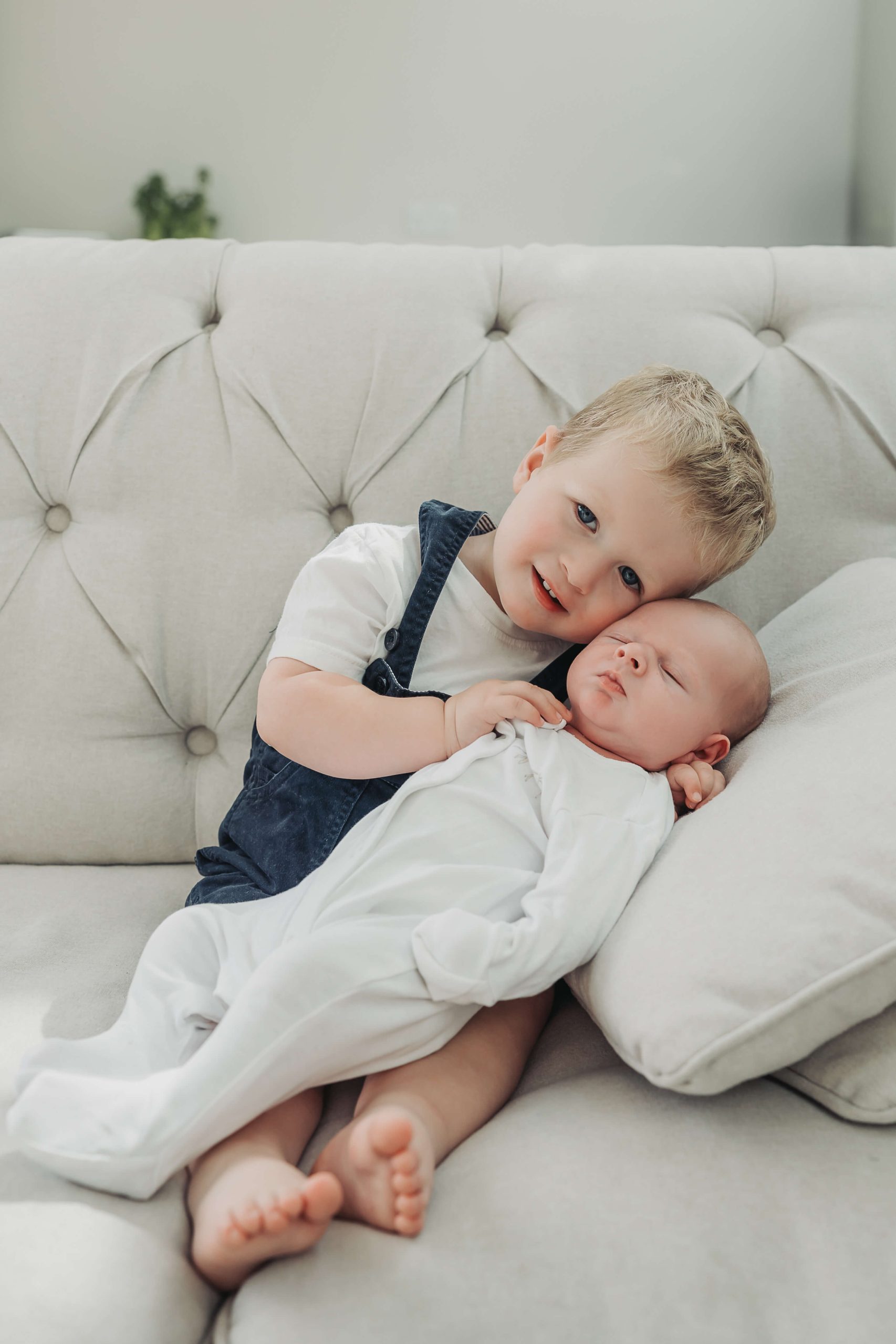 Kenilworth-newborn-photoshoot24 toddler boy leaning and cuddling newborn baby