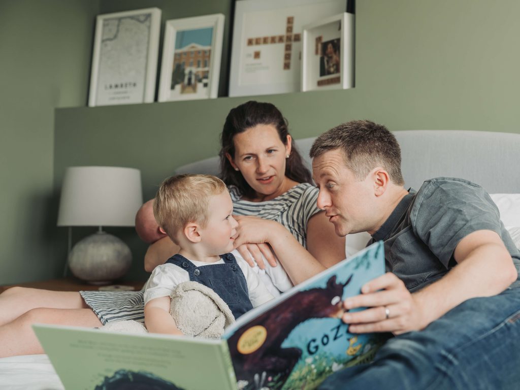 family sharing a story together on the bed