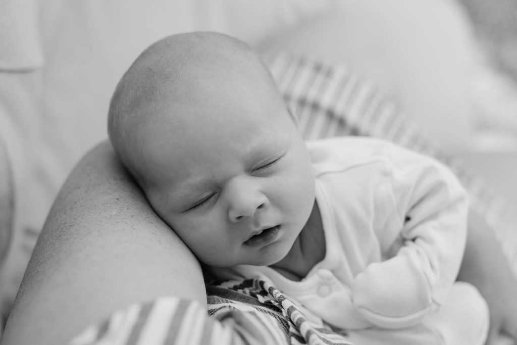 Black and white portrait of newborn baby asleep