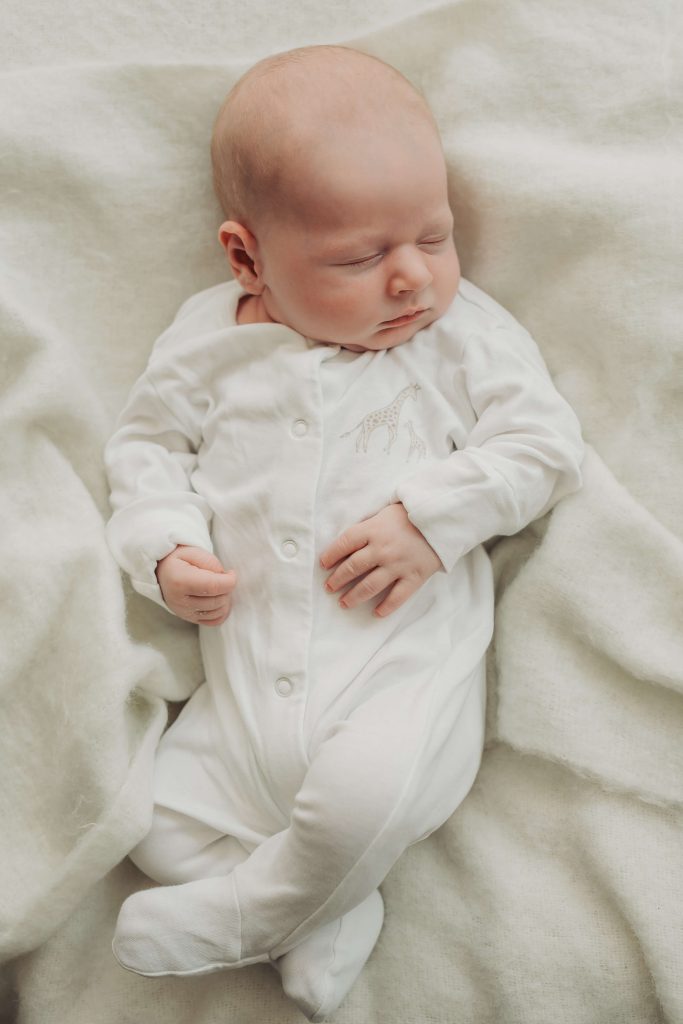 newborn asleep on blanket during in home newborn photoshoot