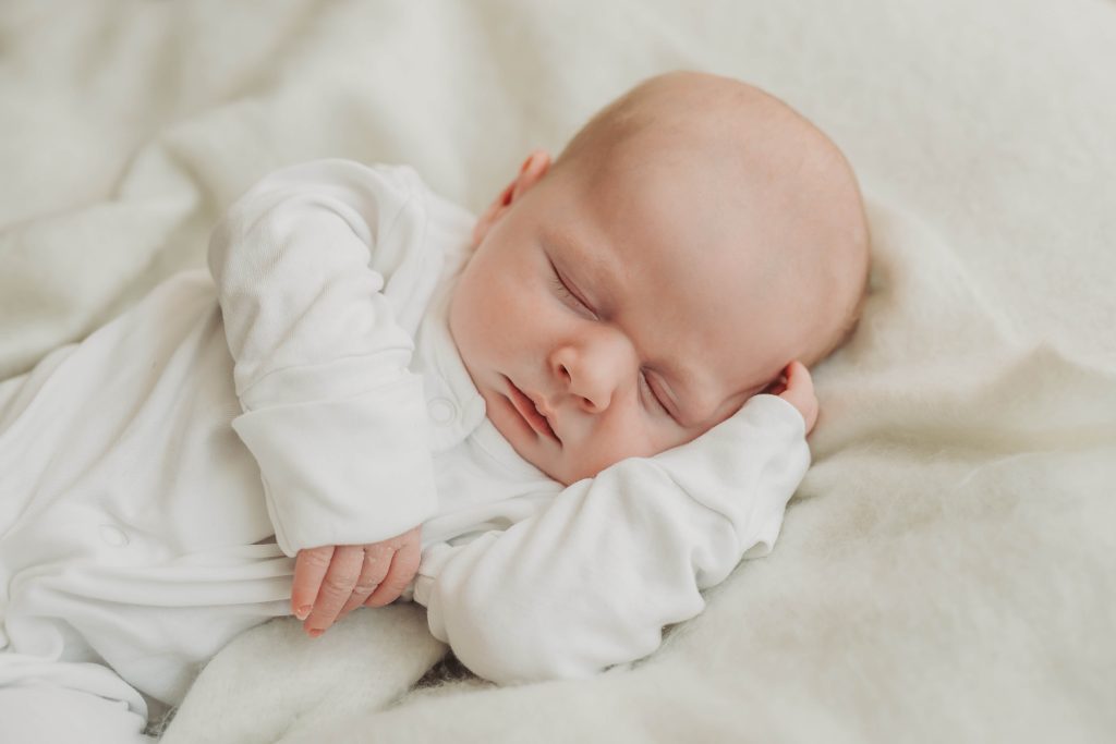 Portrait of sleepy baby during a baby photoshoot at home in Kenilworth