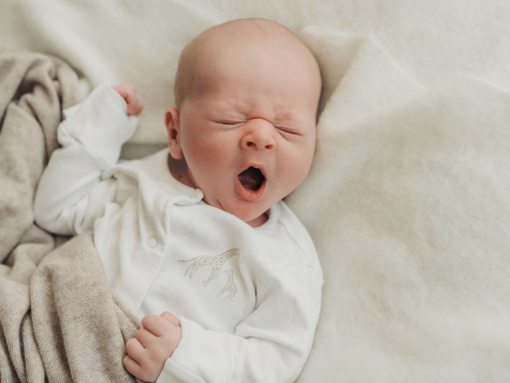 baby having a large yawn