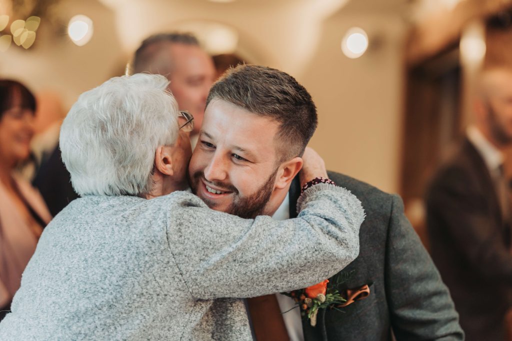 groom hugging old relative at Mythe Barn