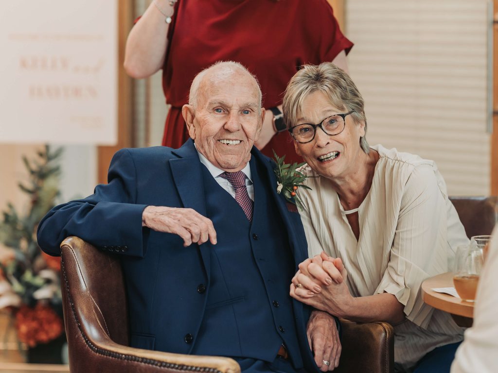 older guests holding hands and smiling at camera Mythe Barn wedding