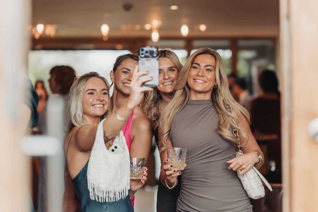 Wedding guests taking selfie at Mythe Barn
