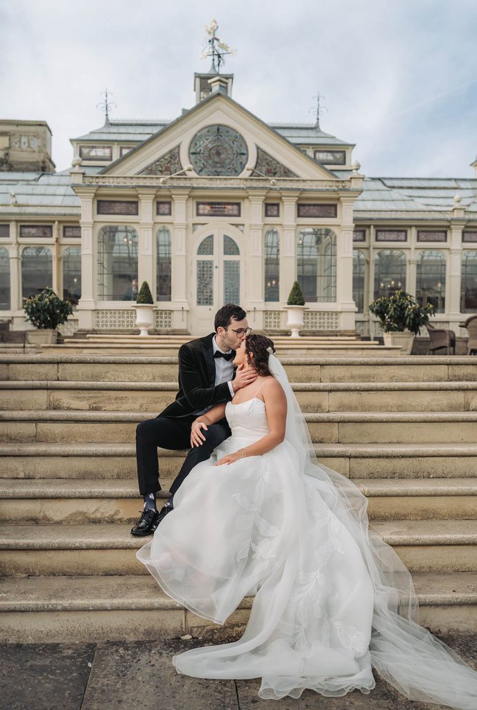 bride and groom sitting on steps at Kilworth House