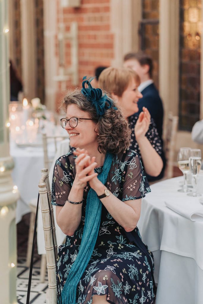 candid photo of wedding guest clapping