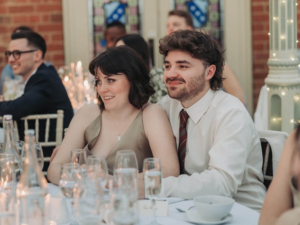 candid photo of wedding guests smiling and hugging