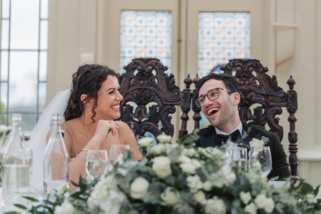 bride and groom laughing in wedding speeches