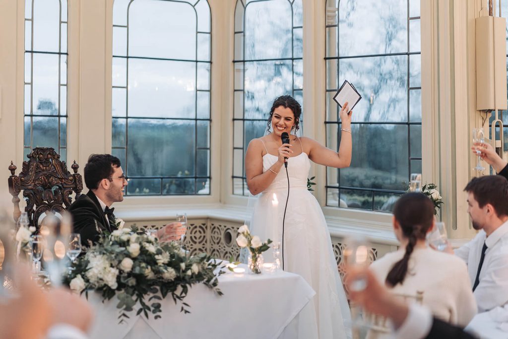 bride giving speech looking happy at Kilworth House
